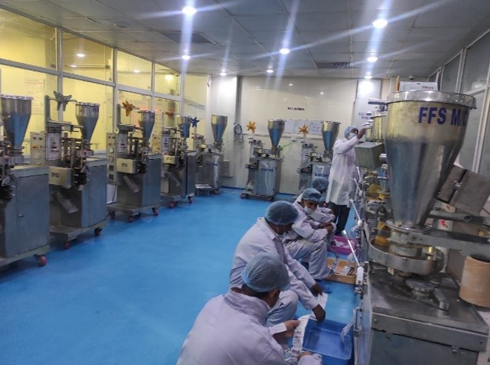 Cleanroom production line with workers operating filling machines