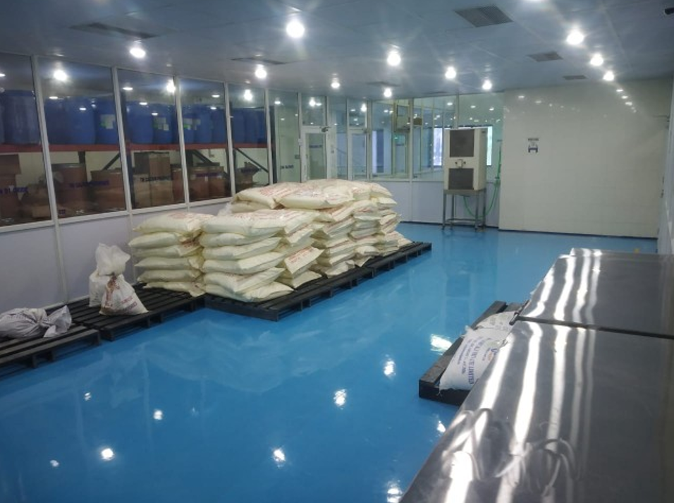 Raw material warehouse with stacked ingredient bags on pallets